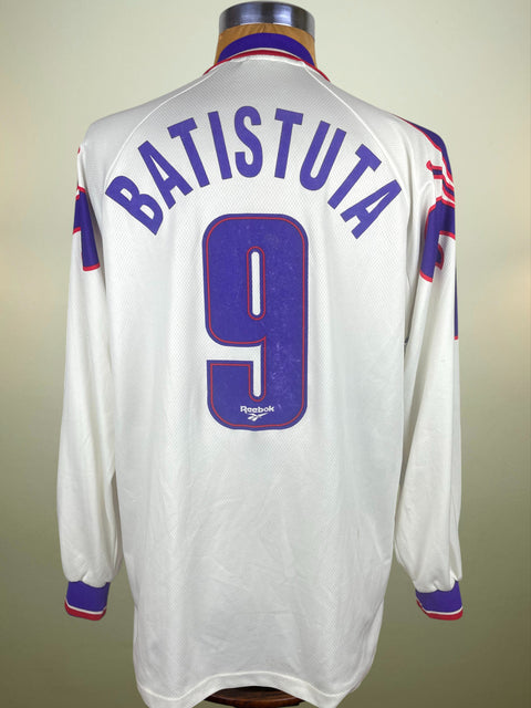 White Fiorentina 1995-96 jersey with 'Batistuta' and number '9' on a mannequin against a beige background