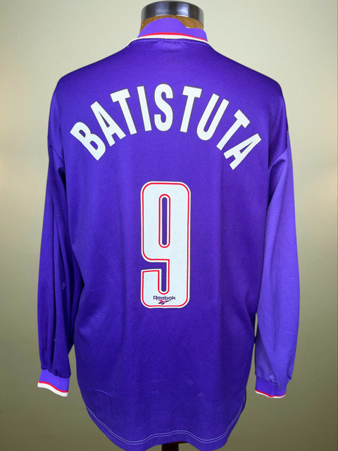 A purple long-sleeve soccer jersey displayed on a mannequin, showing the back with 'BATISTUTA' and the number '9' in white with a red outline.