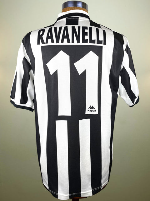 Black and white striped Juventus jersey with 'Ravanelli' and number '11' on a mannequin against a beige background
