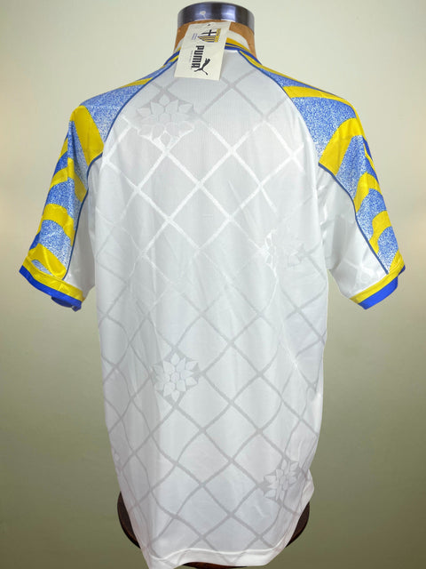 White home Parma Jersey with blue and yellow accents on a mannequin against a plain background