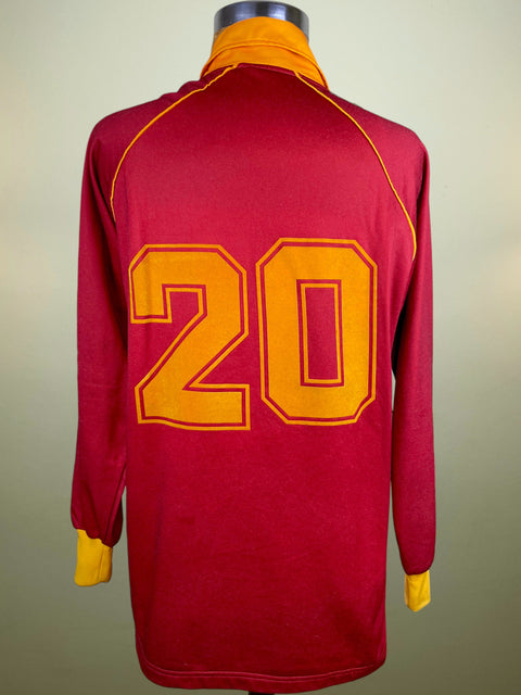 Red AS Roma 1987-88 Ennerre home jersey with yellow number 20 on a mannequin against a beige background