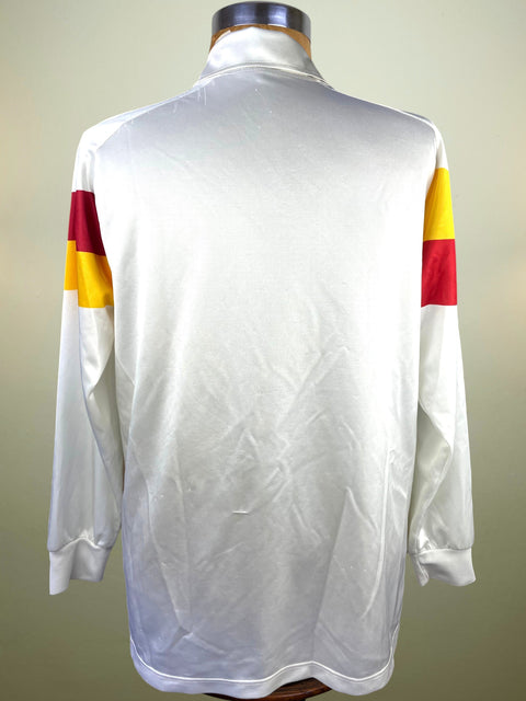 A white long-sleeve collared shirt or jersey displayed on a mannequin, shown from the back. The sleeves have color-blocked sections in red and yellow.