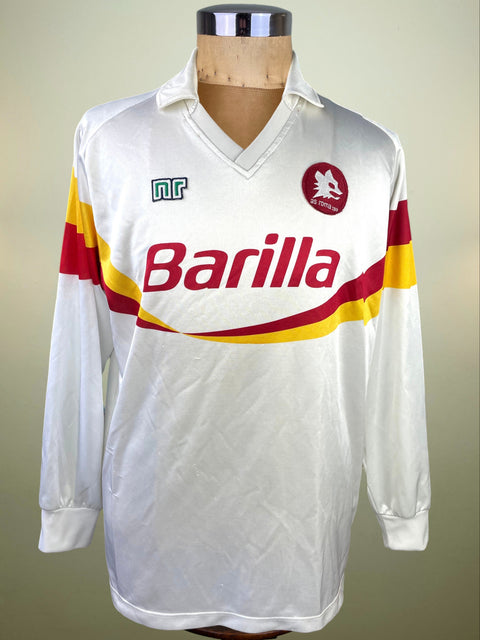 A vintage long-sleeve white soccer jersey displayed on a wooden mannequin torso. The jersey features the red and yellow striped logo of Barilla across the chest, a green and white 'nr' sponsor logo on the right chest, and a circular red and gold club crest on the left chest.