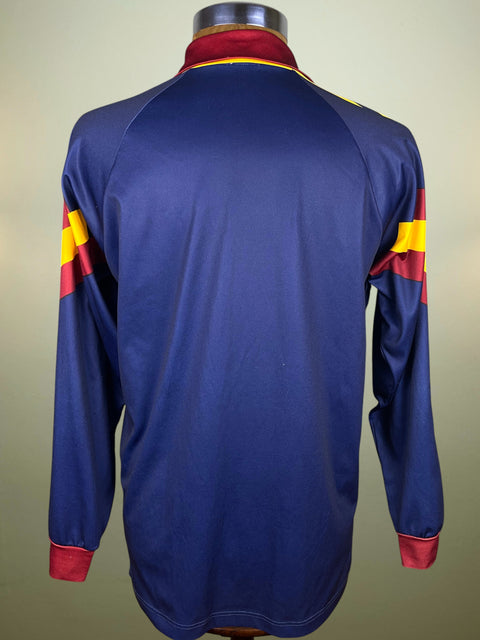 Blue AS Roma 1991 Adidas Third jersey with red and yellow accents on a mannequin against a beige background