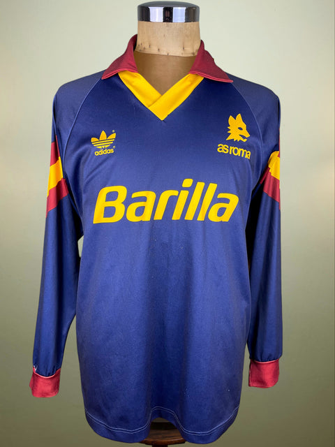 Blue AS Roma rare Third jersey from the 1991-92 season with red and yellow accents and Adidas branding on a mannequin against a beige background