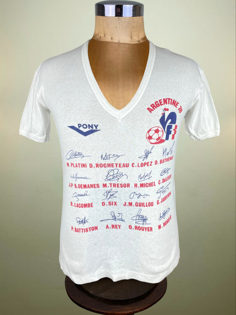 White t-shirt with Pony logo and signatures on a mannequin against a beige background