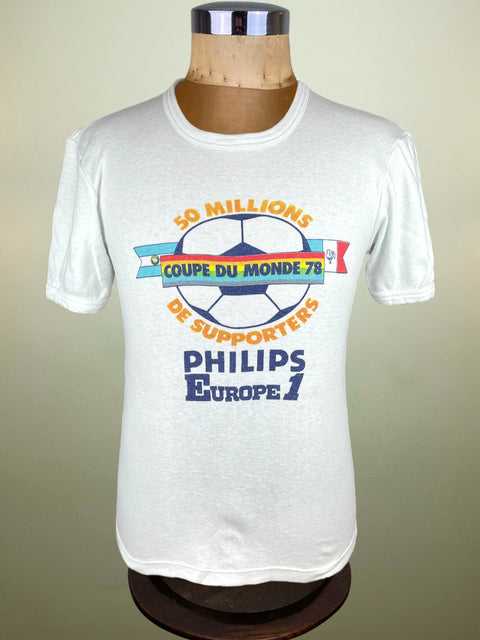 White t-shirt with vintage graphic design on a mannequin against a plain background