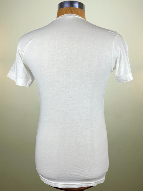 White t-shirt on a mannequin against a beige background