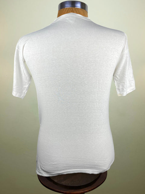 White t-shirt on a mannequin against a beige background