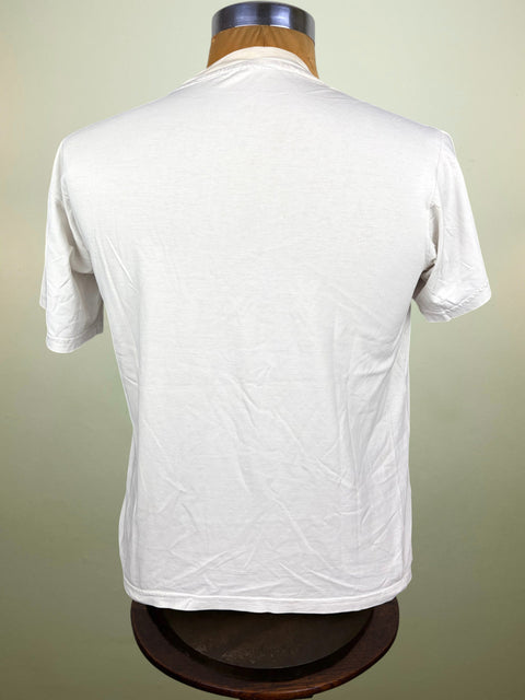 A white short-sleeve crewneck t-shirt displayed on a wooden dress form mannequin, viewed from the back against a light beige background.