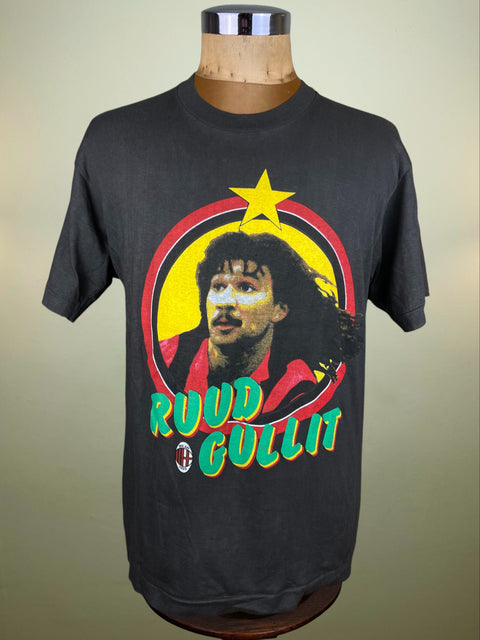 Black t-shirt with a graphic of a man's face and 'Ruud Gullit' text on a wooden mannequin against a beige background