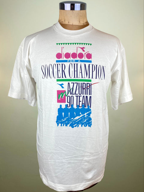 White t-shirt with colorful graphics and text on a mannequin against a beige background