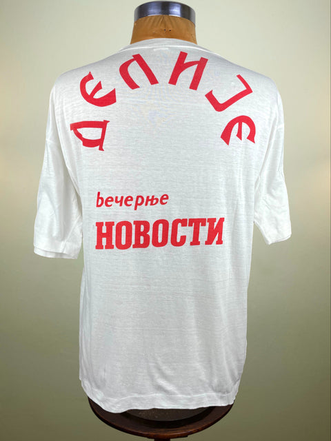 White t-shirt with red text on a mannequin against a neutral background