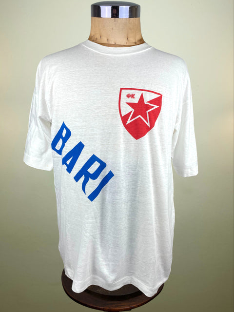 White t-shirt with Red Star Belgrade logo and blue text saying "Bari" on a mannequin against a beige background