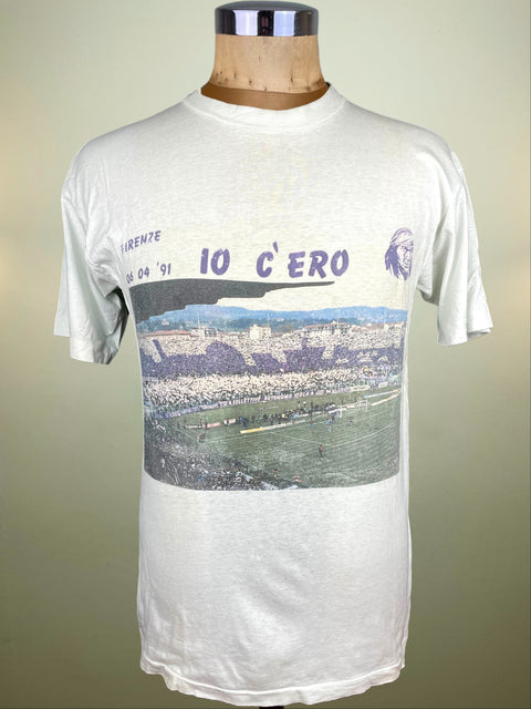 White t-shirt with graphic design on a mannequin against a beige background