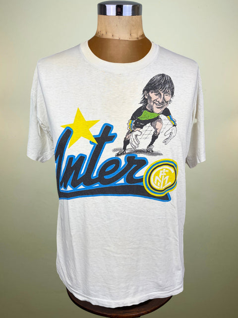A vintage Inter Milan graphic t-shirt displayed on a wooden dress form mannequin. The white short-sleeve tee features a large graphic print with a yellow star, blue 'Inter' script, a yellow/green Inter logo badge, and a cartoon caricature of goalkeeper, Walter Zenga.