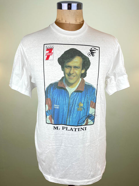 White t-shirt with a graphic of a football player and text on a mannequin against a plain background