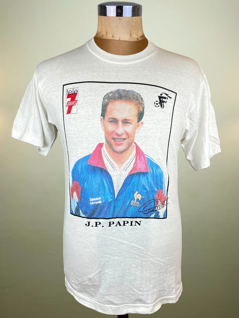 White t-shirt with a graphic of a man in a blue sports jacket and text 'J.P. Papin