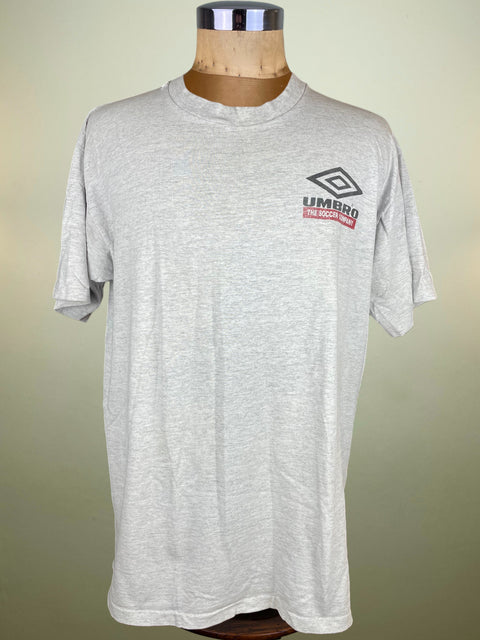 Gray t-shirt with Umbro logo on a mannequin against a beige background