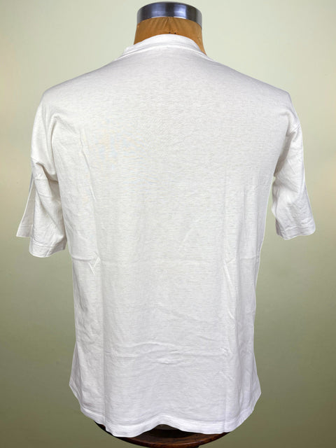 A white short-sleeve t-shirt displayed on a wooden dress form mannequin, showing the back view against a light beige background.