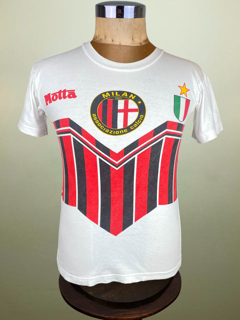 White t-shirt with red and black striped design on a mannequin against a beige background