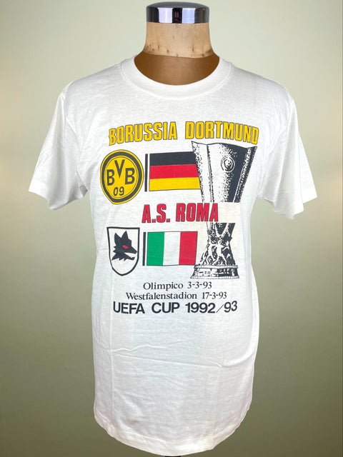 White t-shirt with Borussia Dortmund and A.S. Roma graphics on a mannequin against a plain background