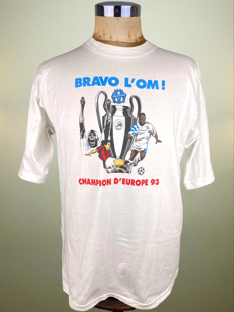 White Marseille Champions League Winners with sports-themed graphics and text on a mannequin against a plain background