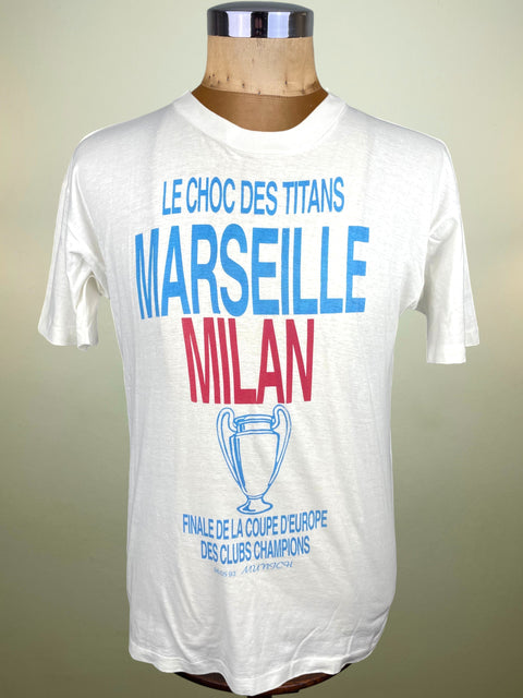 White t-shirt with text and a trophy graphic on a mannequin against a beige background