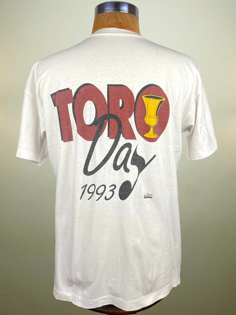 White t-shirt with 'Toro Day 1993' design on a mannequin against a neutral background