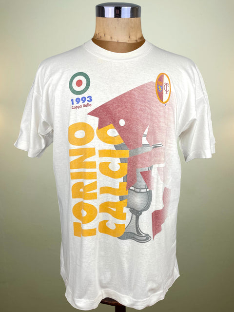 White t-shirt with colorful graphics and text on a mannequin against a plain background