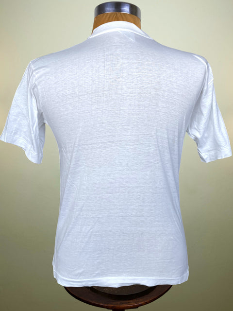 White short-sleeve polo shirt shown from the back on a wooden dress form mannequin against a light beige background.