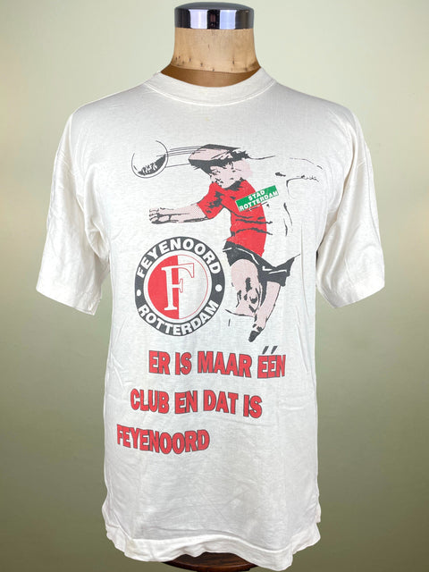 White t-shirt with a graphic design and text on a mannequin against a plain background
