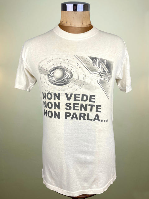 White t-shirt with graphic design and text on a mannequin against a plain background