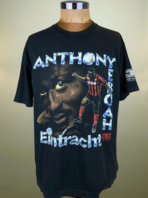 Black t-shirt with a graphic of a football player and text on a mannequin against a beige background