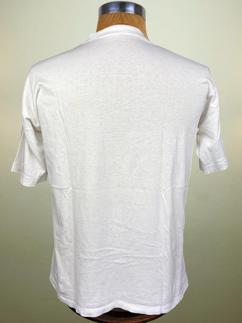 A white short-sleeve t-shirt displayed on a wooden dress form mannequin, showing the back view against a light beige background.