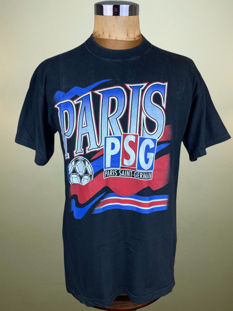 Black t-shirt with 'Paris PSG' text and logo on a mannequin against a beige background