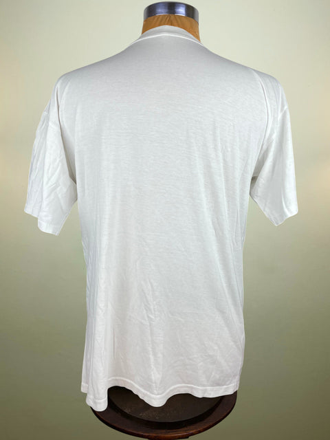 White t-shirt on a mannequin against a plain background