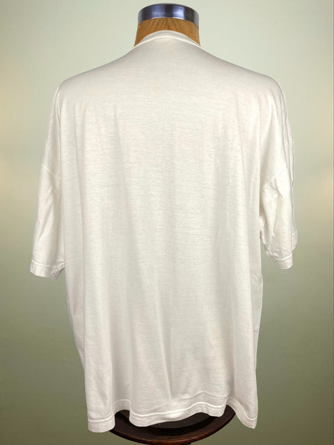White long-sleeve shirt on a mannequin against a plain background