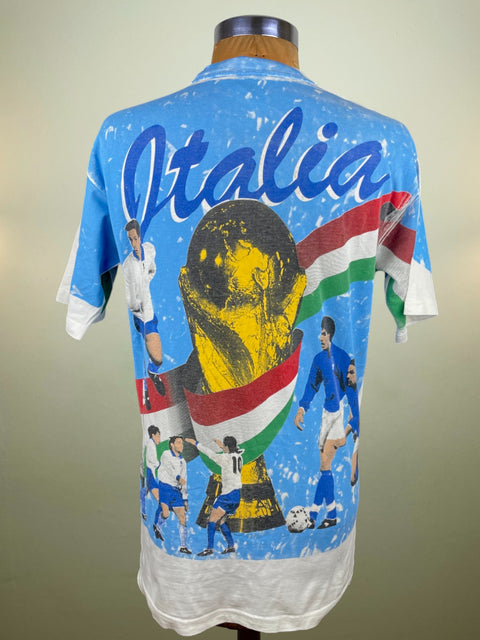Vintage Italy soccer jersey with national team players and 'Italia' text on a blue background.