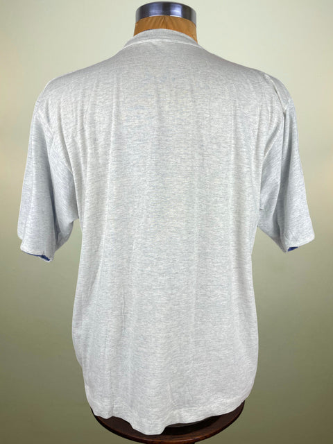 Gray polo shirt on a mannequin against a beige background