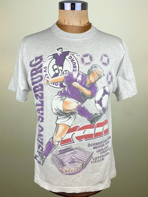 Gray t-shirt with soccer graphic on a mannequin against a beige background