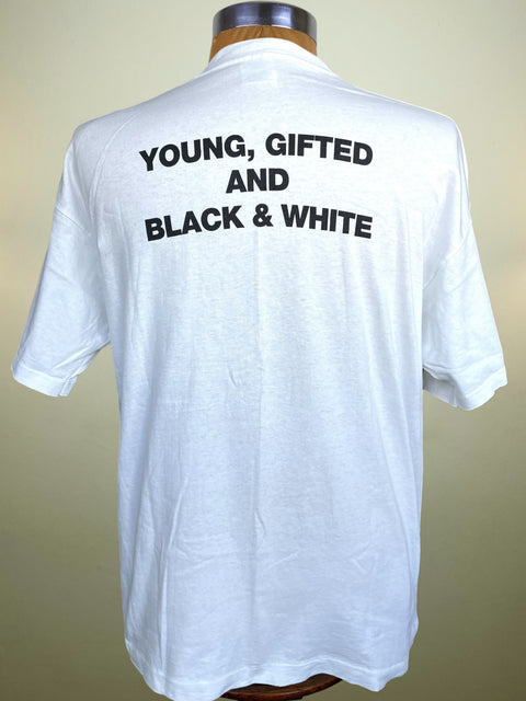 A white short-sleeve t-shirt displayed on a mannequin torso, showing the back with the text 'YOUNG, GIFTED AND BLACK & WHITE' printed in bold black capital letters.