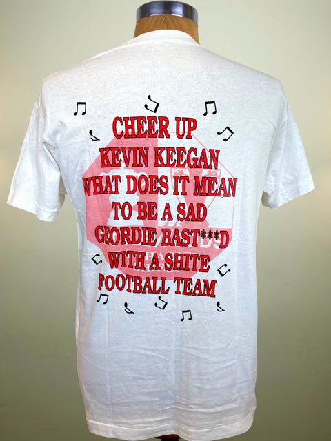 White short-sleeve t-shirt displayed on a mannequin torso, showing the back with a large red and pink graphic text design and small black music note accents.