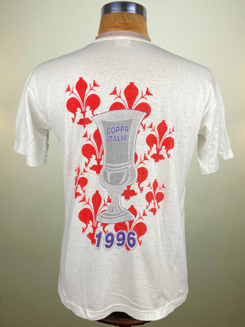 White t-shirt with red floral design and trophy graphic on a mannequin against a beige background