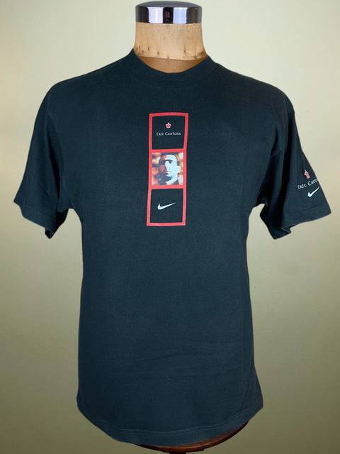 Black t-shirt with a graphic design on a mannequin against a beige background