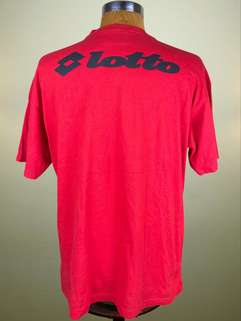 Red t-shirt with 'Lotto' logo on a mannequin against a beige background