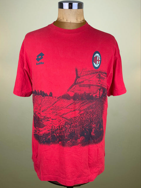 Red Lotto AC Milan t-shirt with black graphic design on a mannequin against a beige background