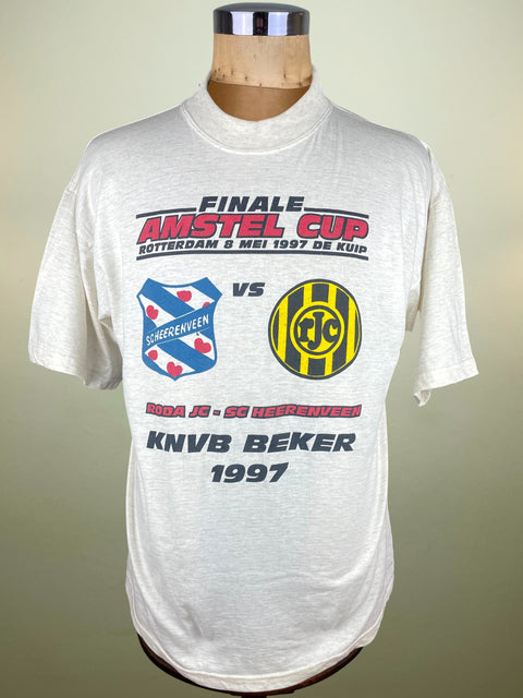 White t-shirt with sports event graphics on a mannequin against a plain background