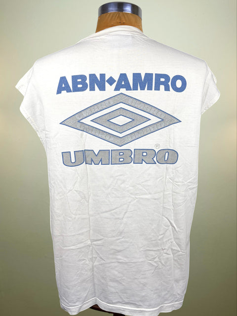 White short-sleeve t-shirt displayed on a mannequin torso, showing the back with blue 'ABN AMRO UMBRO' text and the Umbro diamond logo.