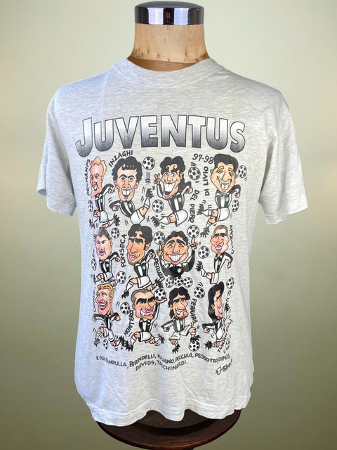 Gray t-shirt with cartoon character design and 'Juventus' text on a mannequin against a beige background